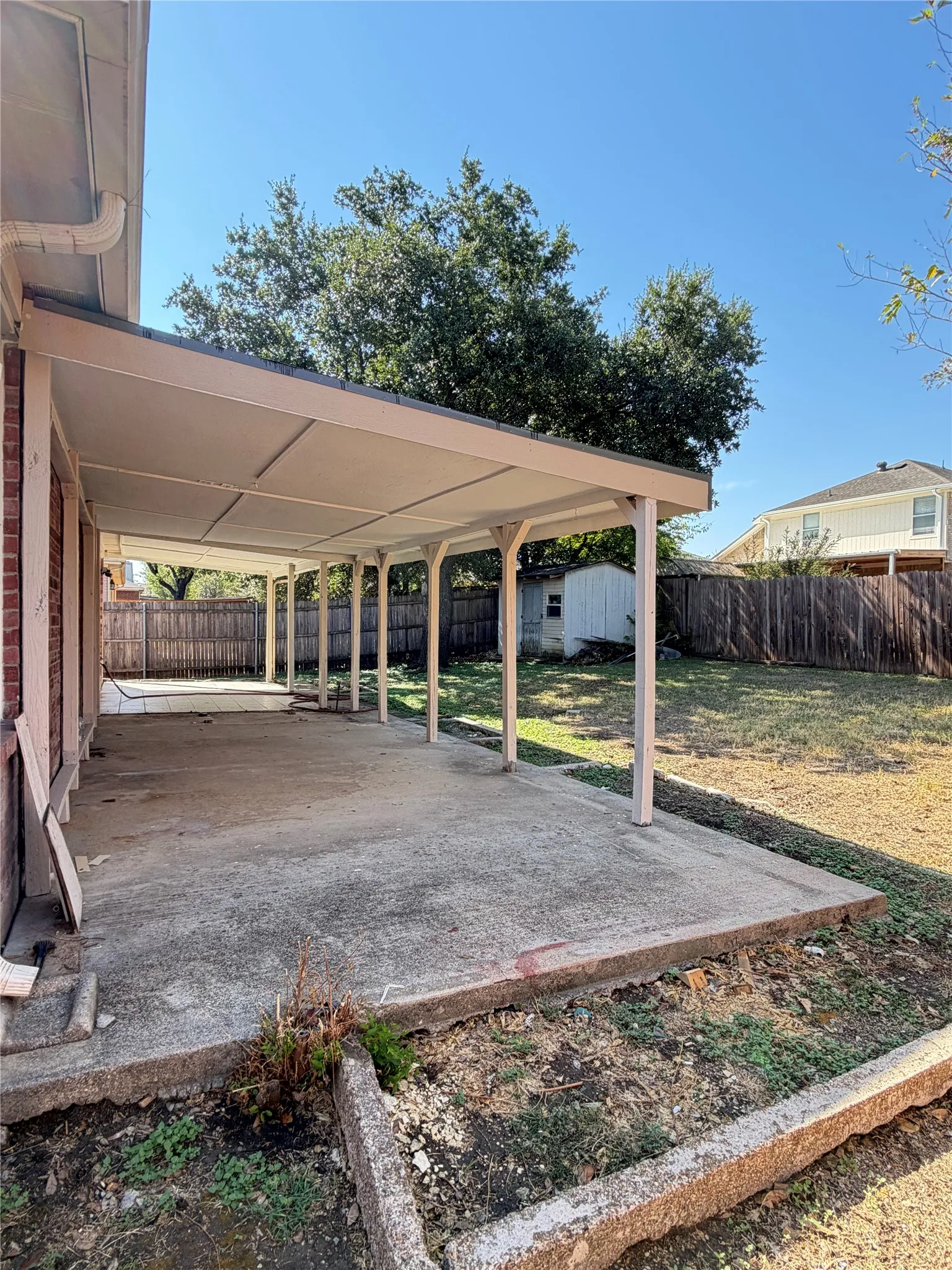 Attached covered patio featuring a concrete slab and support columns