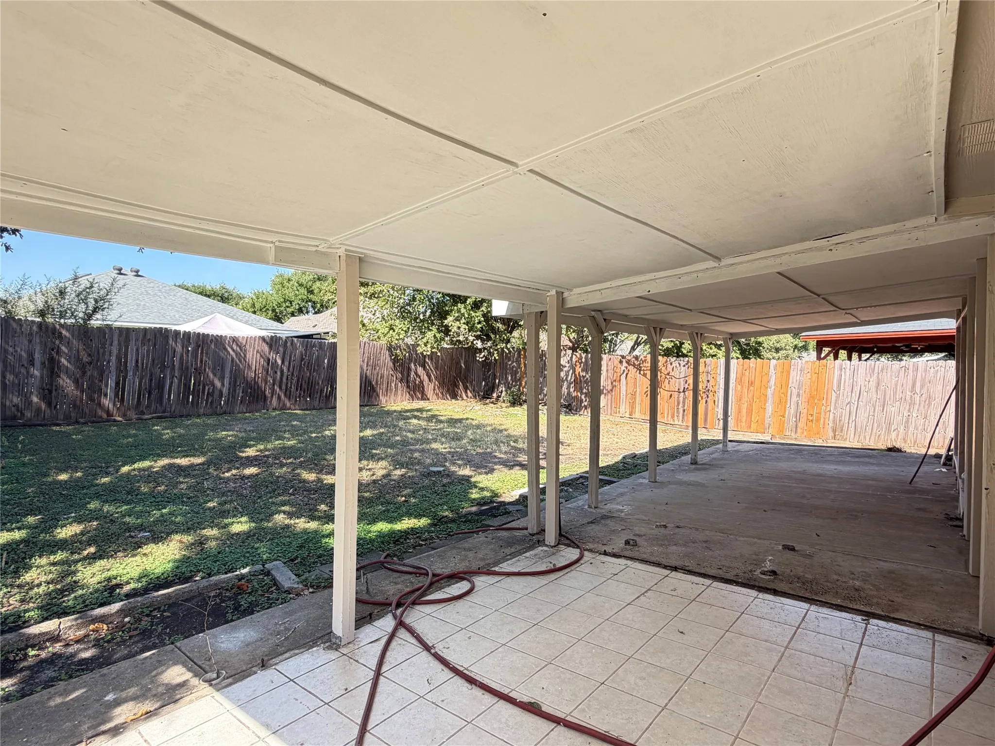 Expansive covered patio with a tiled surface