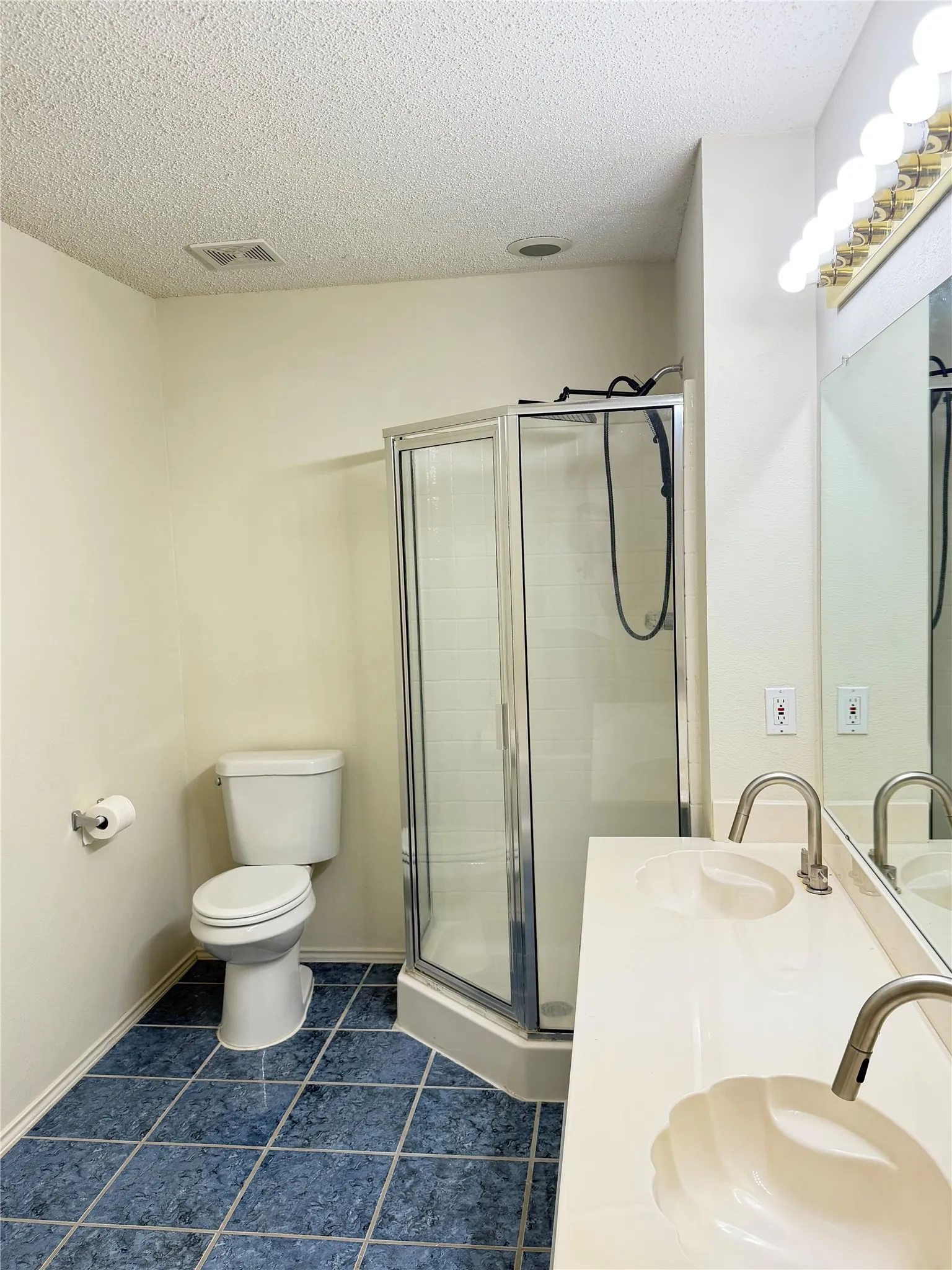 Wood-finish flooring, two windows with blinds, ceiling fan with integrated lighting, and neutral wall tones