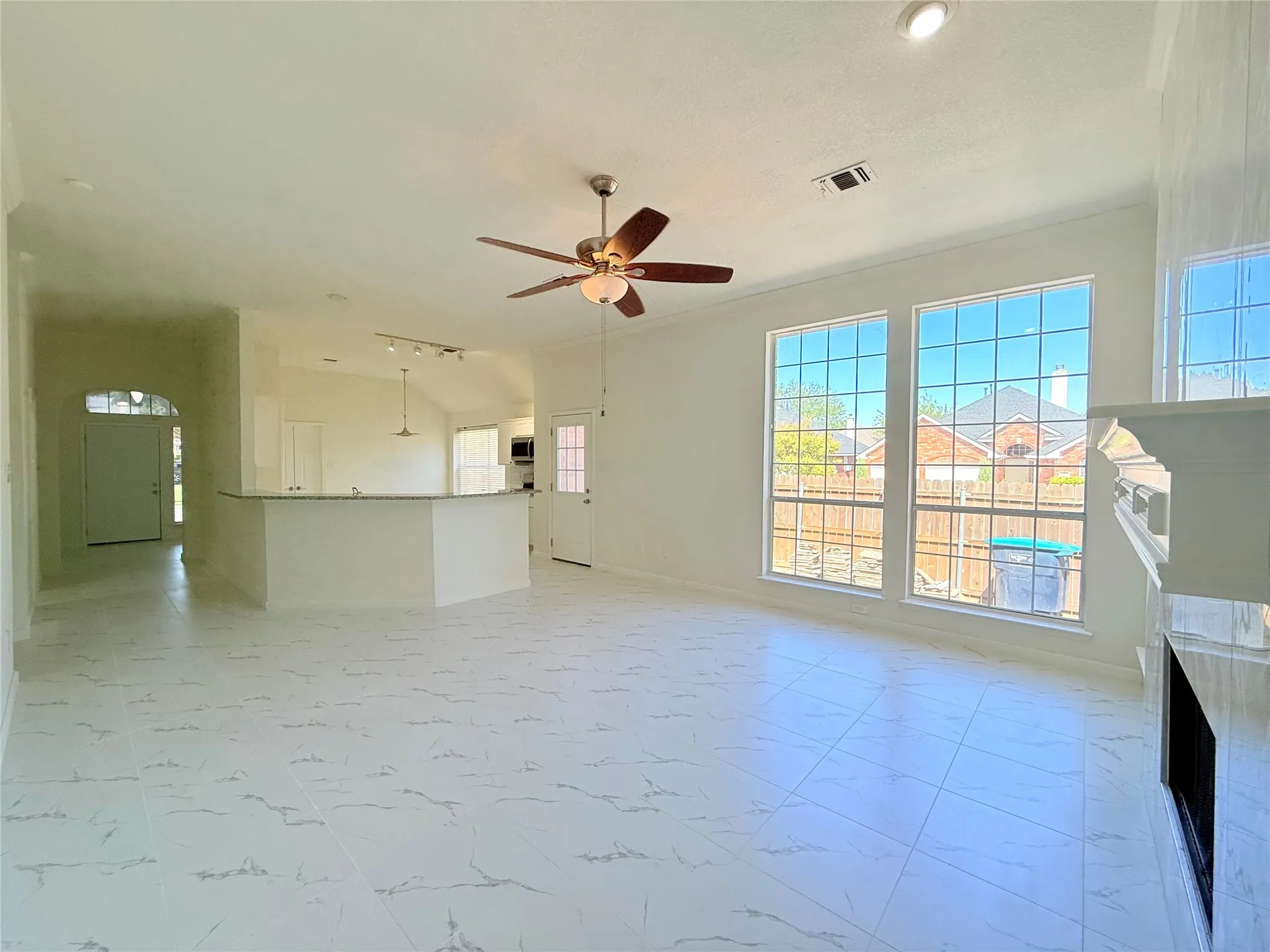 White tile flooring, ceiling fan, recessed lighting, expansive windows, built-in fireplace