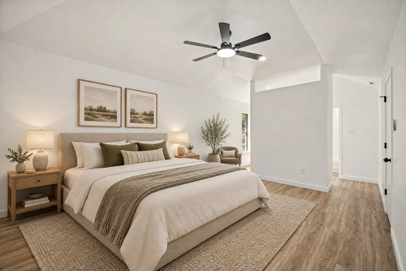 Vaulted ceiling with a ceiling fan, light wood-finish flooring, and white walls