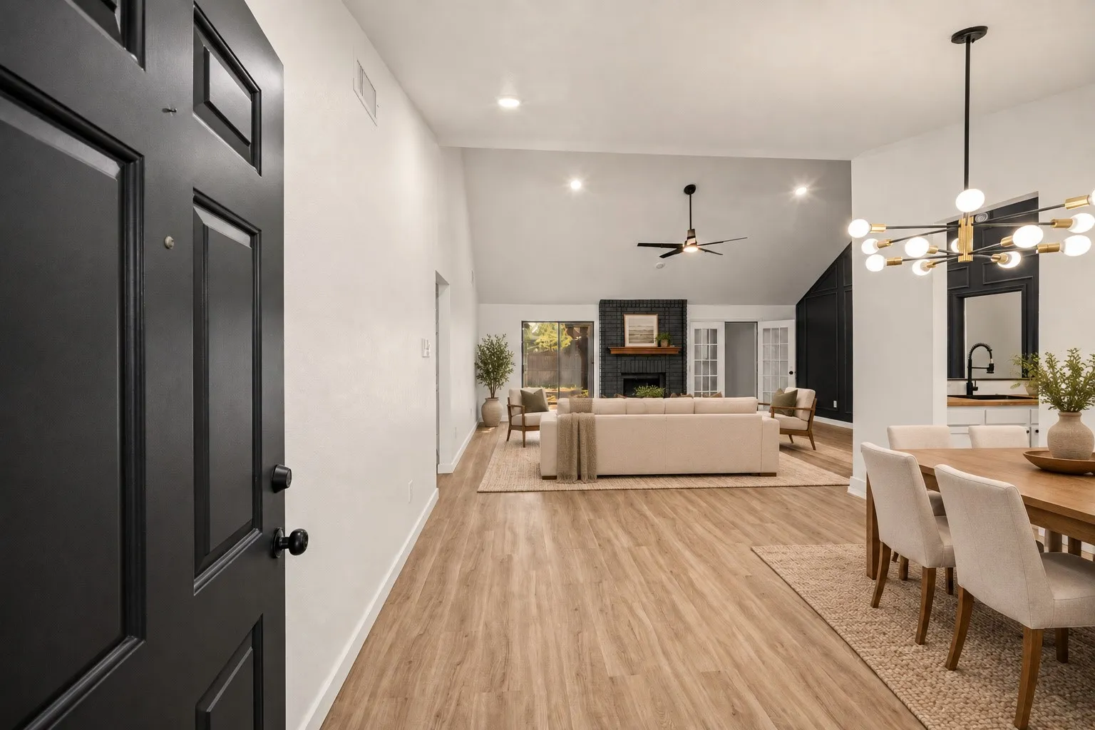 Vaulted ceilings with recessed lighting, wood-finish flooring, and a modern sputnik chandelier