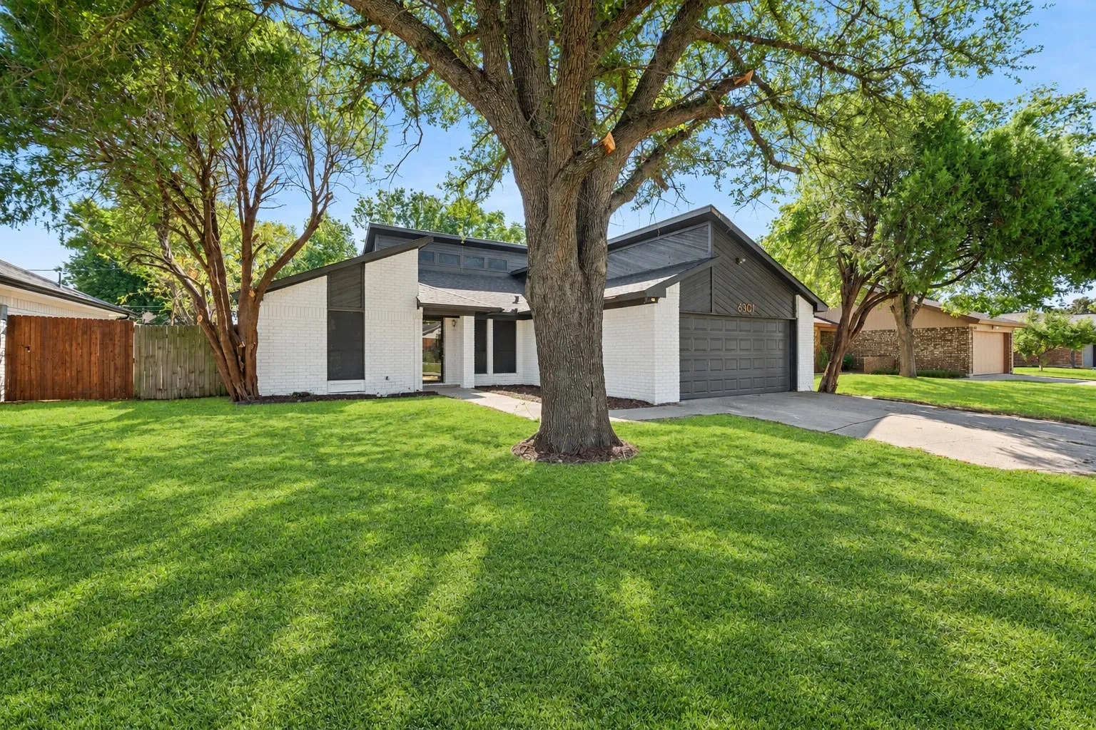 Modern exterior facade with white painted brick and dark siding accents