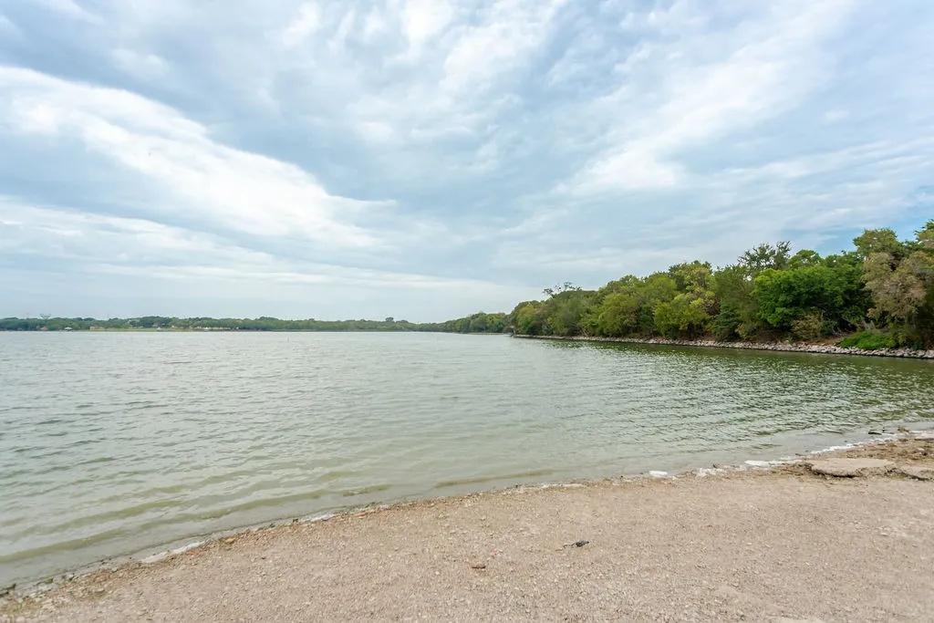 Waterfront property featuring a natural shoreline with mature trees