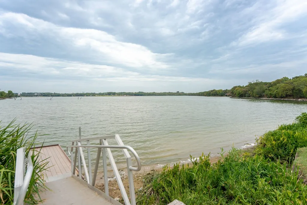Private dock with handrails extending into the lake