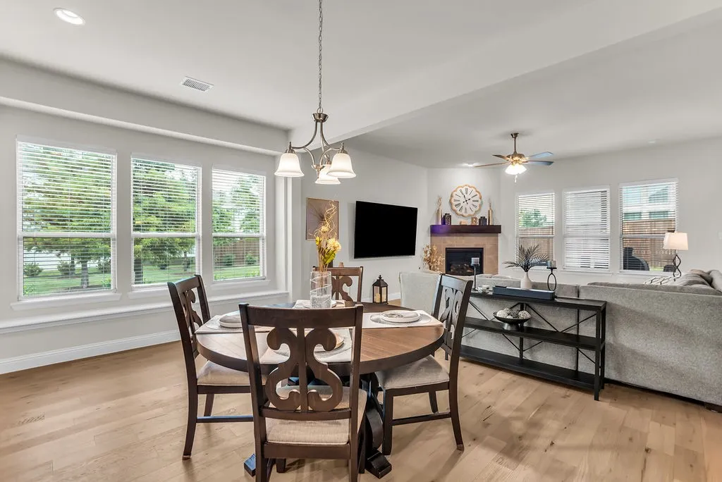 Wood-finish flooring throughout, a modern chandelier, and recessed lighting