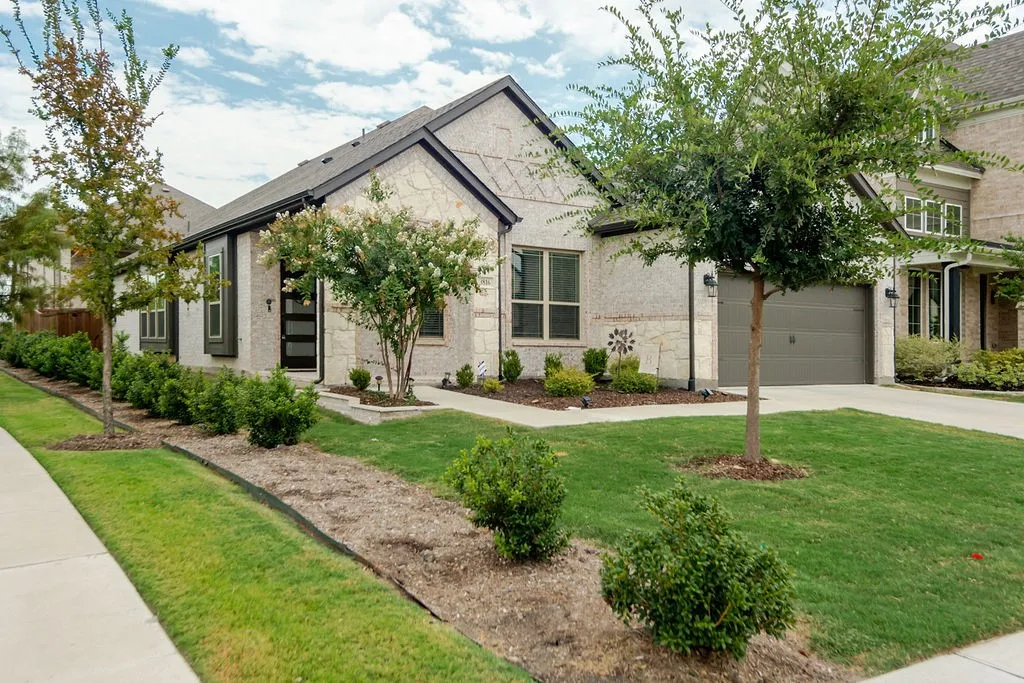 Stone veneer exterior with dark trim accents and a modern front door
