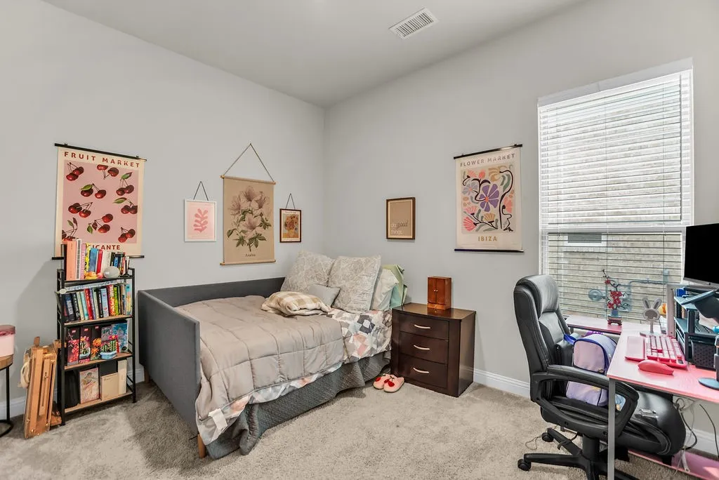 Carpeted room featuring light gray walls, a single window with blinds, and a built-in ceiling light