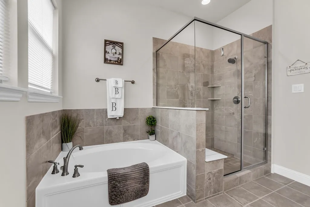 Corner soaking tub with dark bronze fixtures