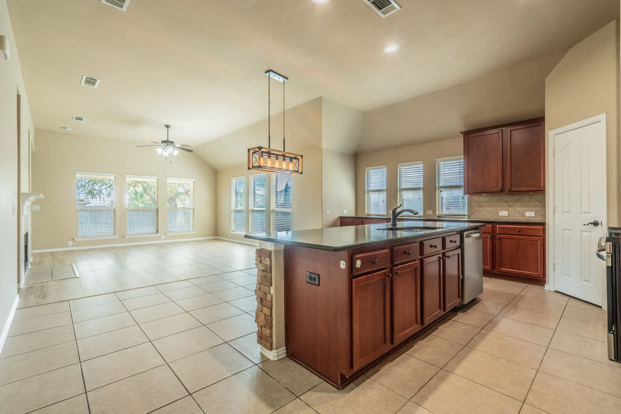 Spacious open-concept living area with vaulted ceilings and recessed lighting