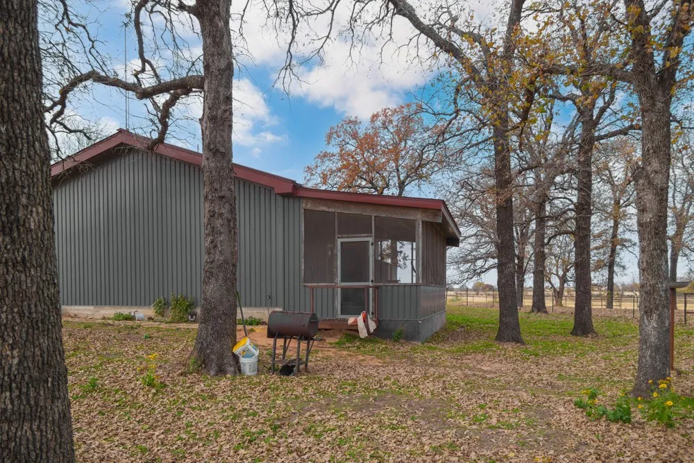 Corrugated metal siding with a red-toned roofline