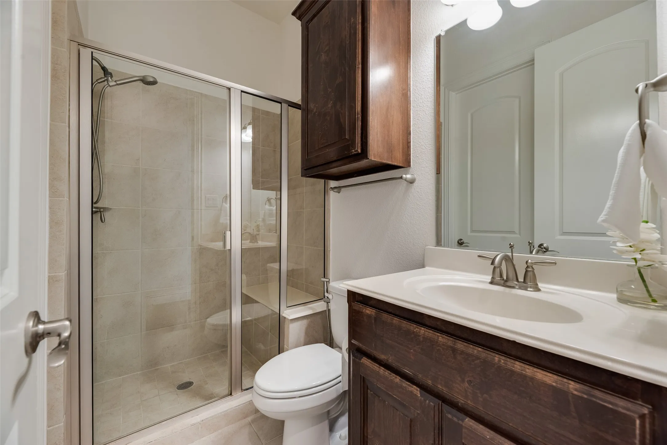 2nd Bathroom Downstairs. Bathroom for 2nd Downstairs Bedroom. Glass-enclosed shower with tiled walls and flooring