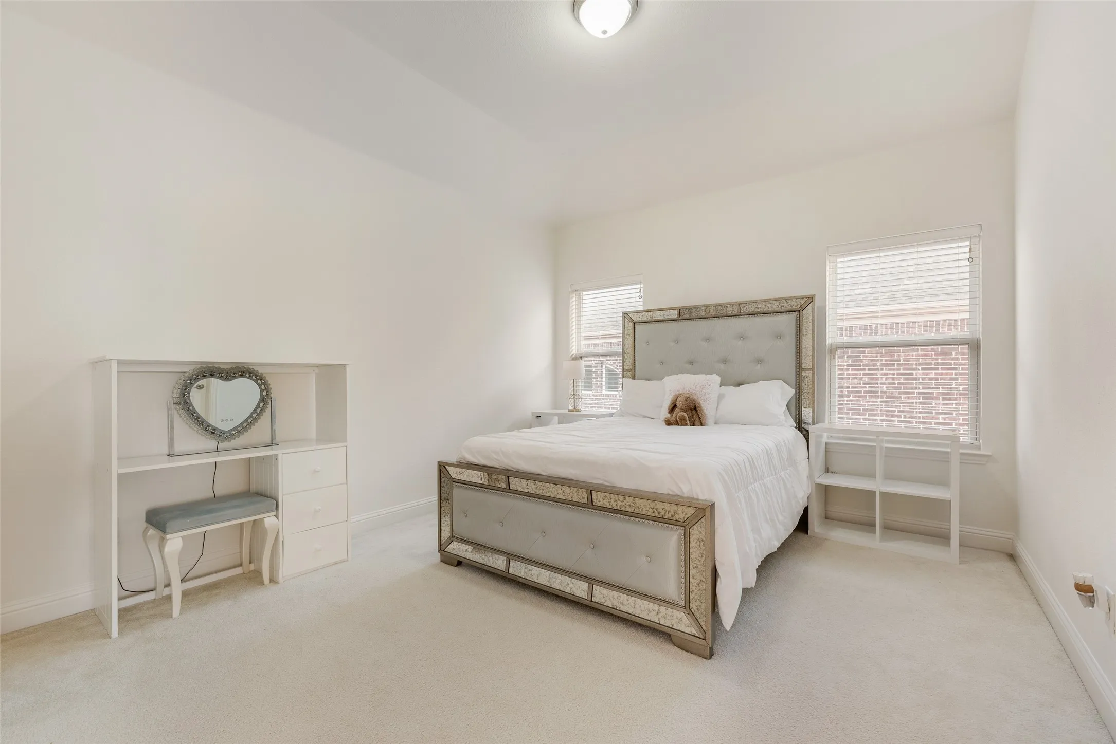 White walls and light-toned carpeting create an open atmosphere