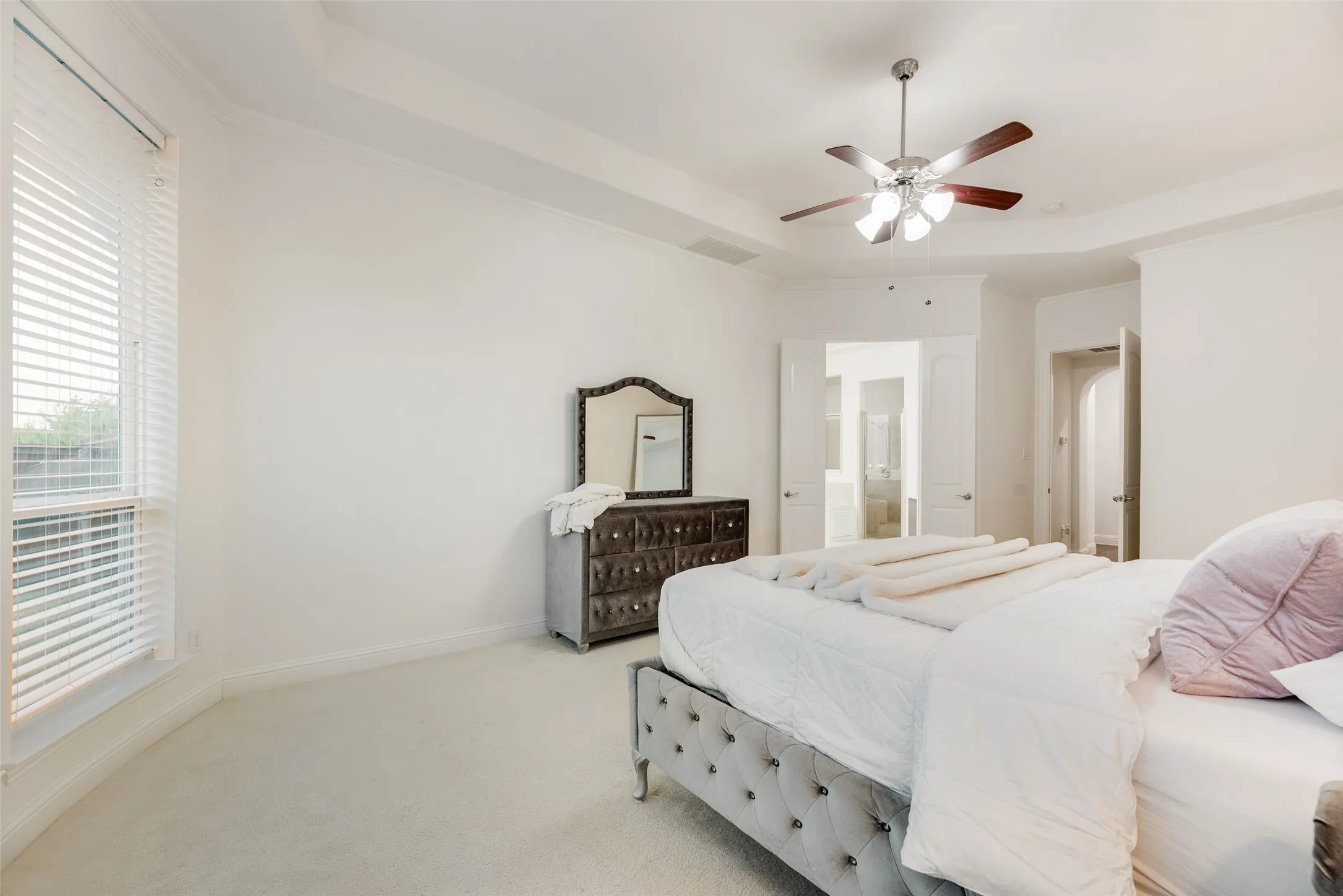 Tray ceiling, recessed lighting, ceiling fan, carpet flooring, and window with blinds