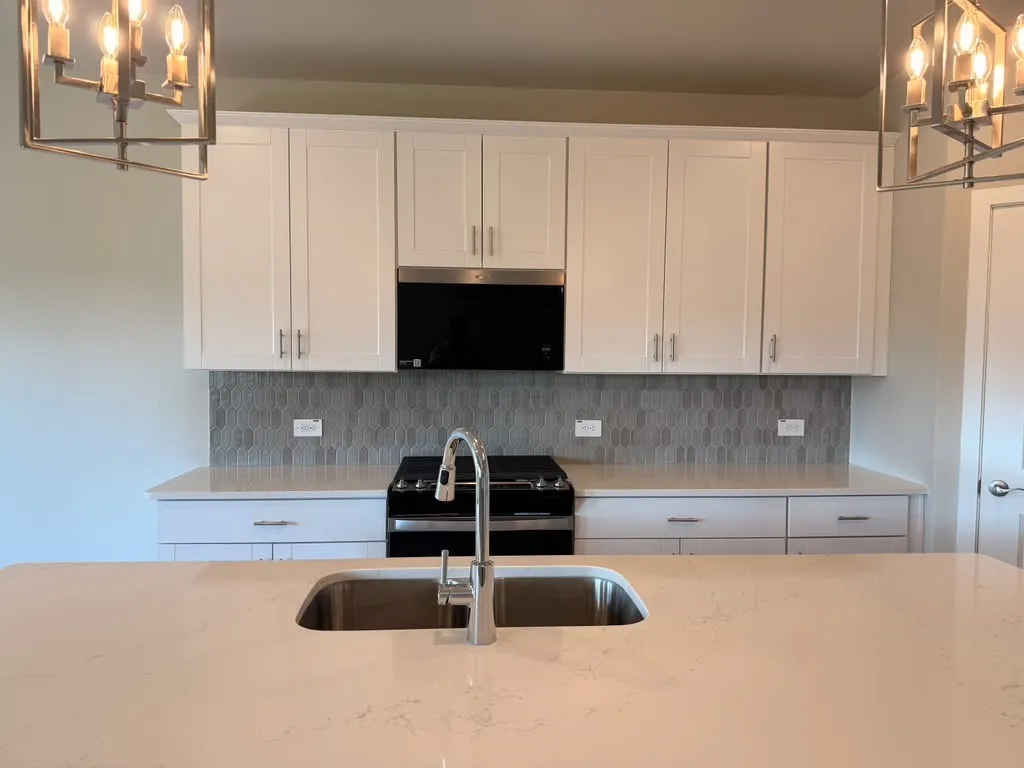 Spacious kitchen island with an undermount sink and a gooseneck faucet