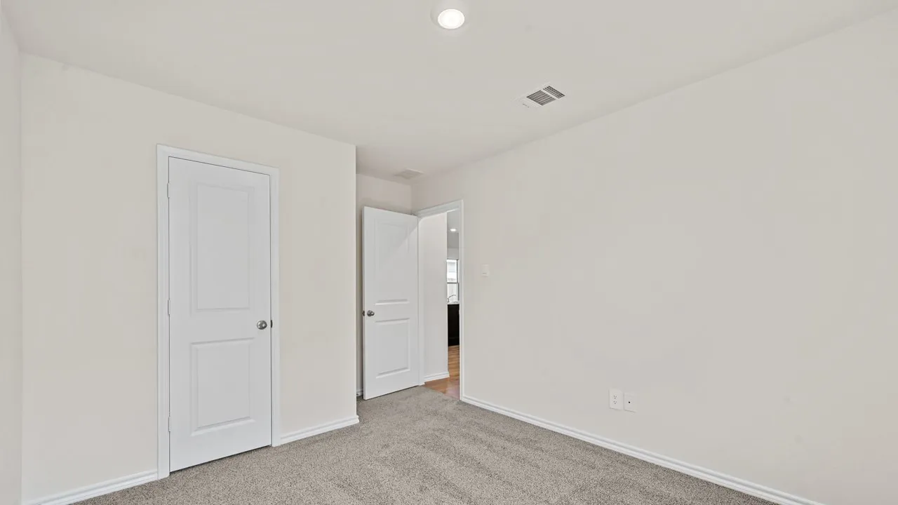 Neutral wall paint, gray carpet, and white trim