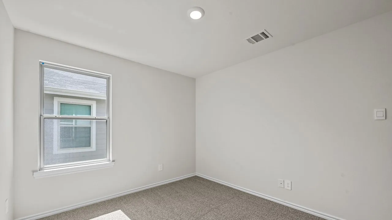 Neutral wall finish, recessed ceiling lighting, light gray carpet, double-hung window with screens, white window trim