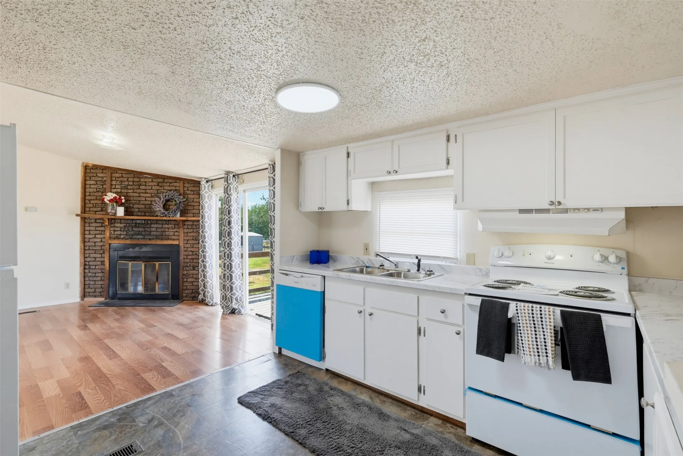 Kitchen featuring white cabinetry and appliances