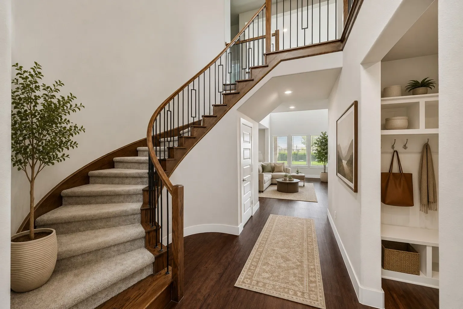 Curved staircase with wood-finish handrail and carpeted treads, wood-finish flooring, built-in shelving with coat hooks, and recessed lighting