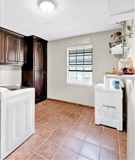 Rich wood-finish cabinetry, tile flooring, and overhead lighting