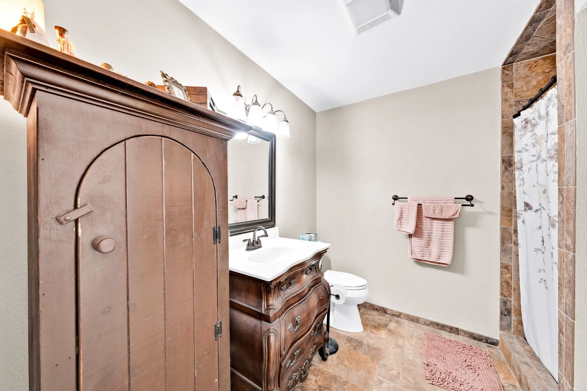 Built-in wood armoire with arched paneling