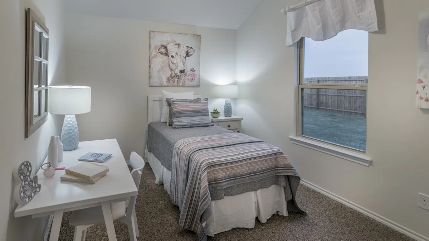 Carpeted bedroom featuring a built-in window and light-toned walls
