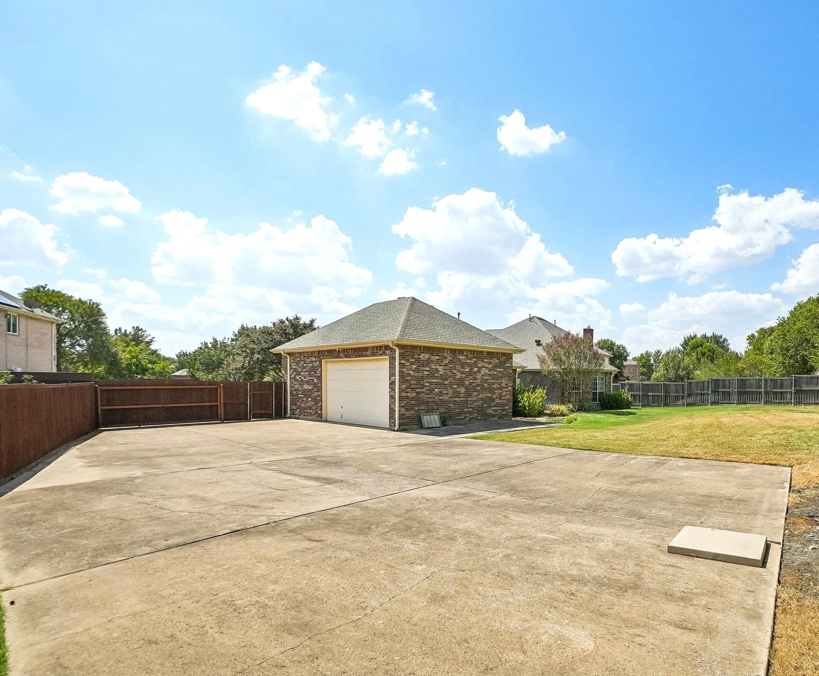 Extra large parking space behind the privacy gate for all your vehicles with additional space for an inground pool.