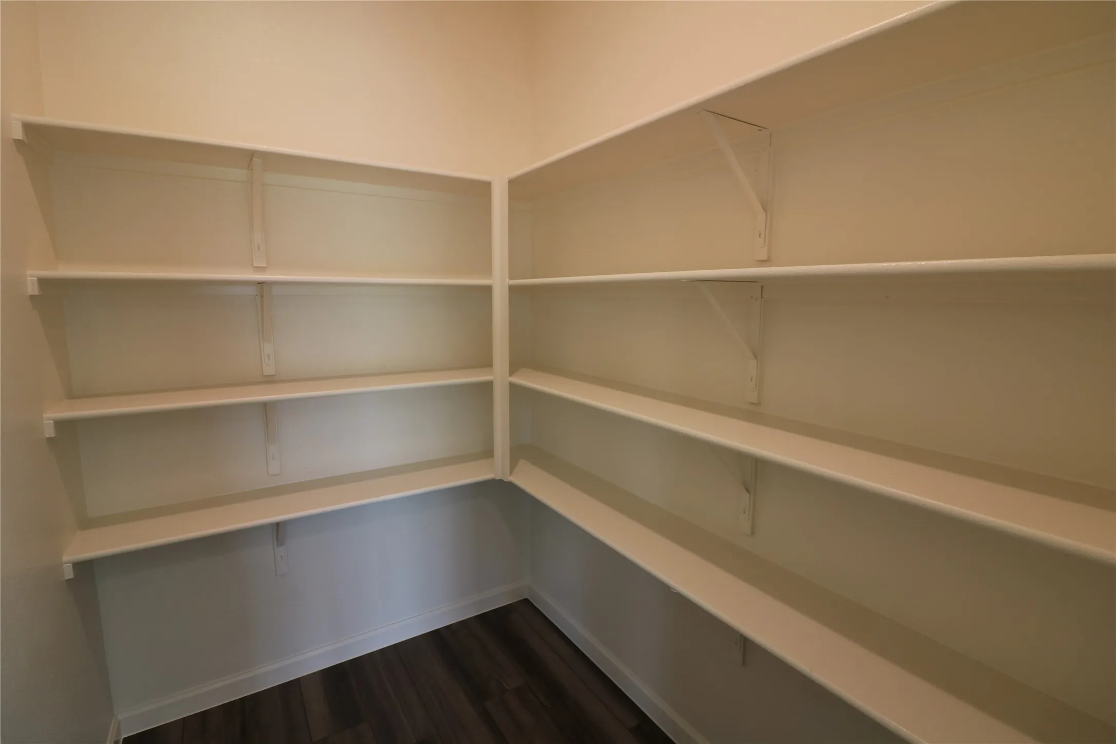 Built-in shelving units with white finish, providing extensive storage space