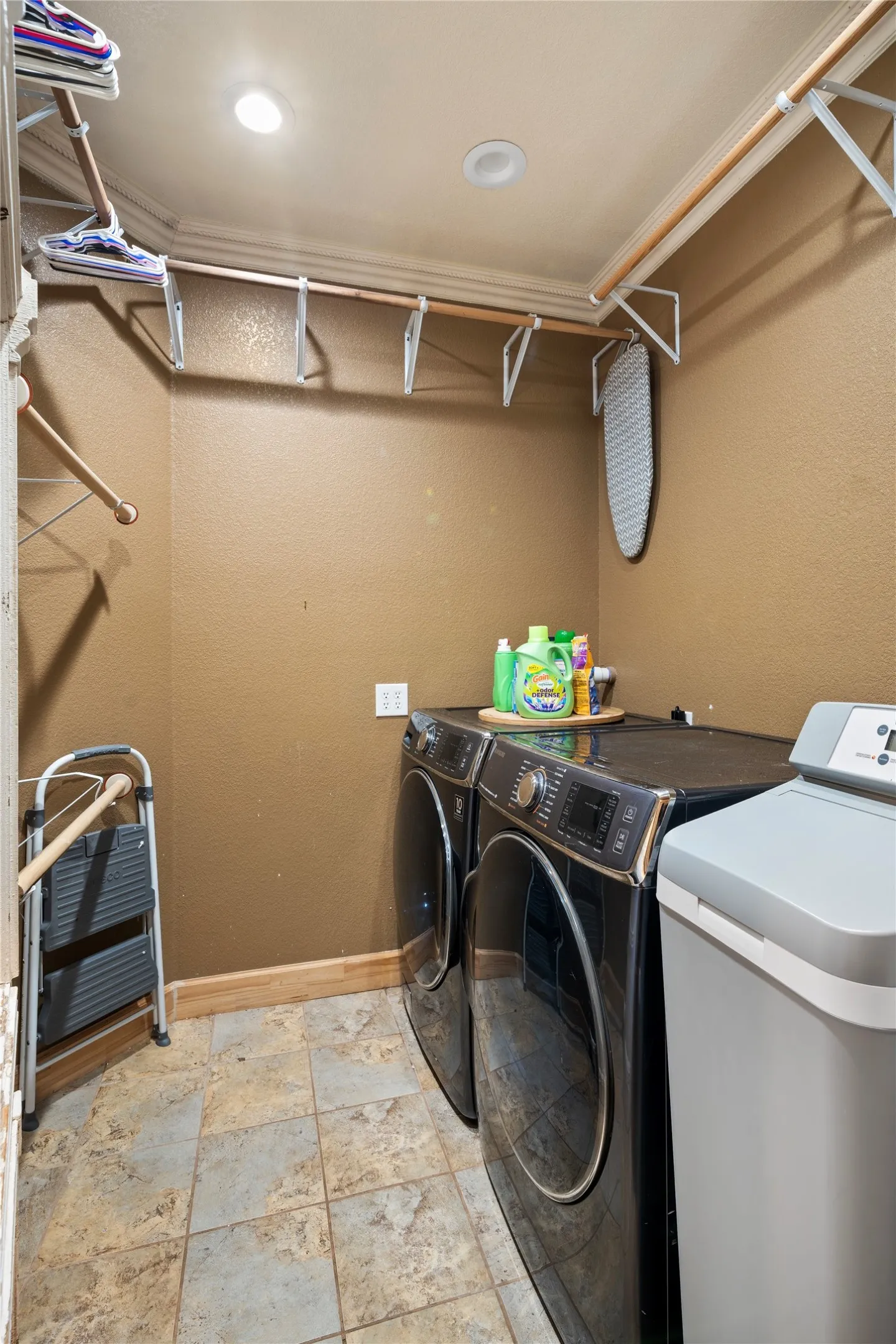 Recessed ceiling lighting, crown molding, and tiled flooring
