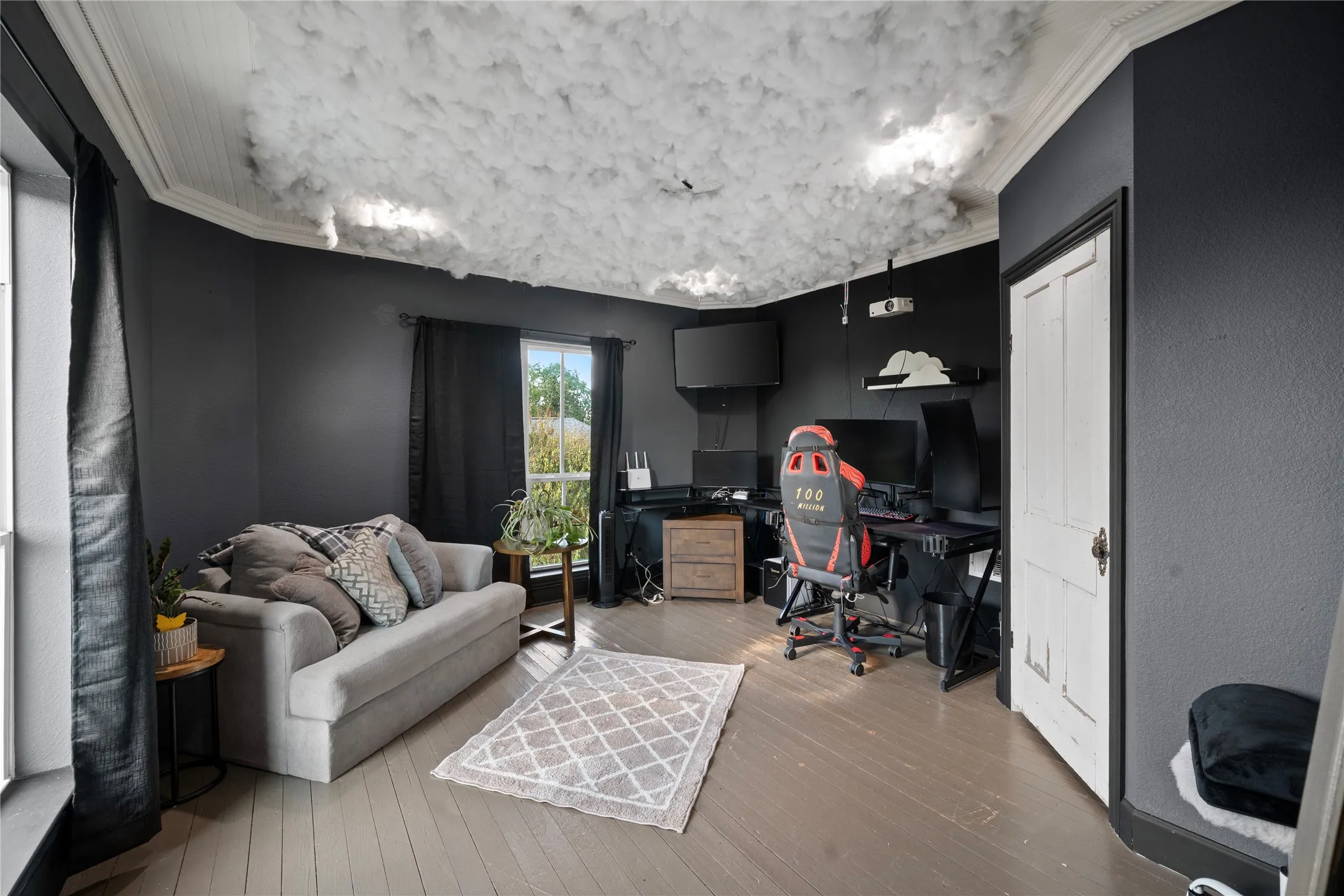 Distinctive ceiling design, light wood-finish flooring, white trim accents, and multiple windows