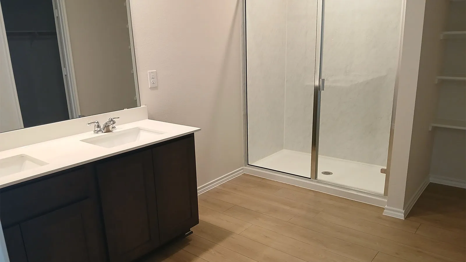 Dual vanity with undermount sinks, white countertop, and chrome fixtures