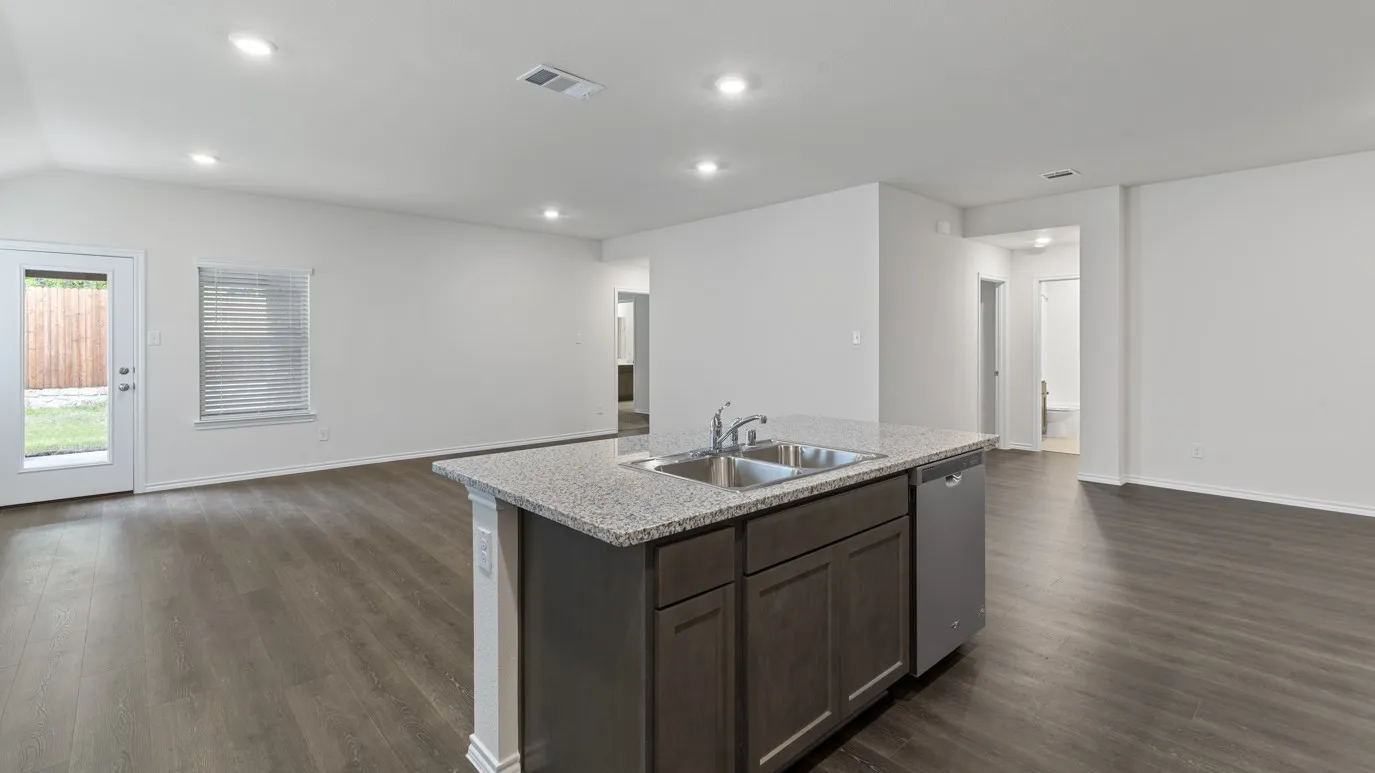 Open-concept living space with wood-finish flooring and recessed lighting