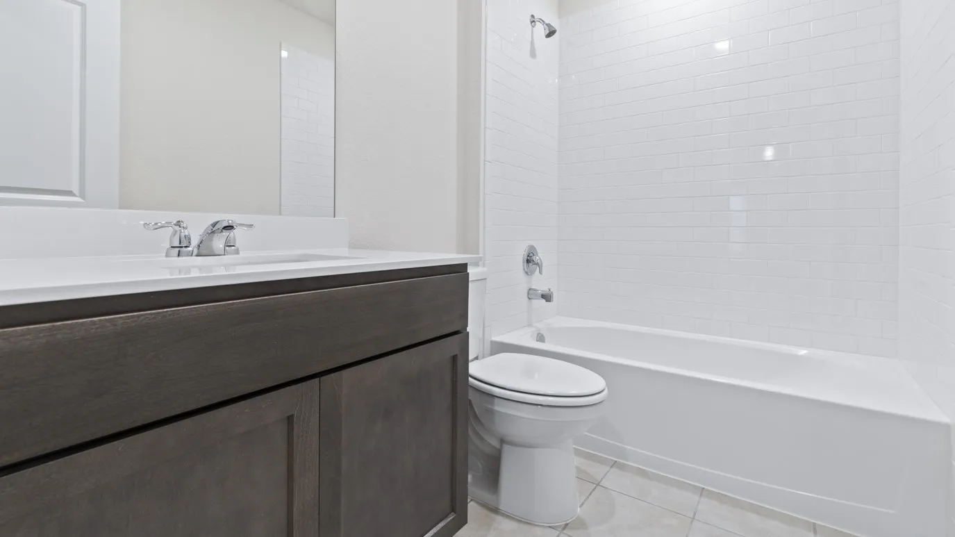 Vanity with a white countertop and chrome faucet