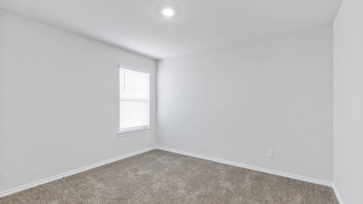 Recessed ceiling light, neutral wall paint, window with horizontal blinds, carpeted flooring