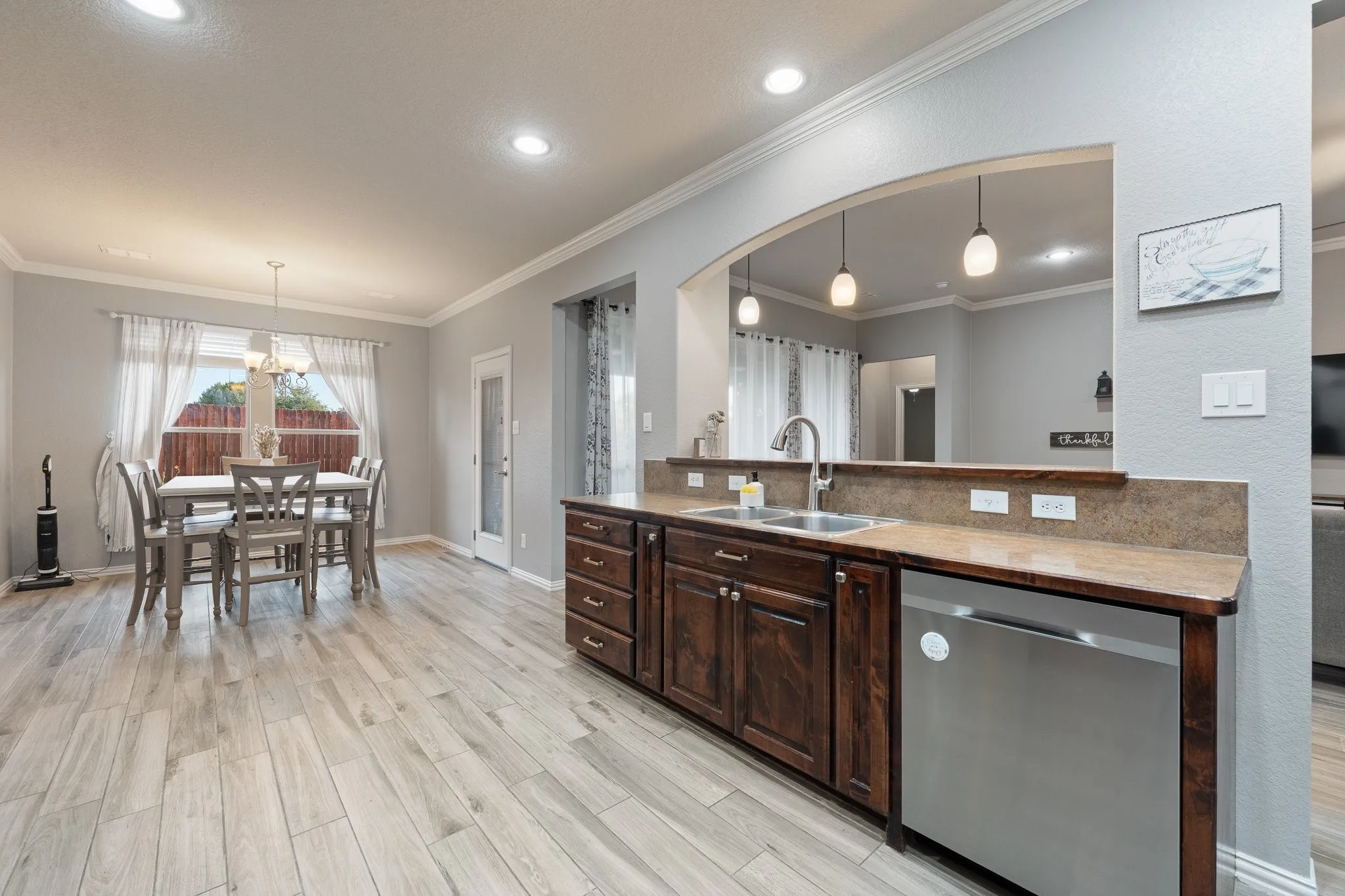 Kitchen has stainless appliances and is open to the living room.