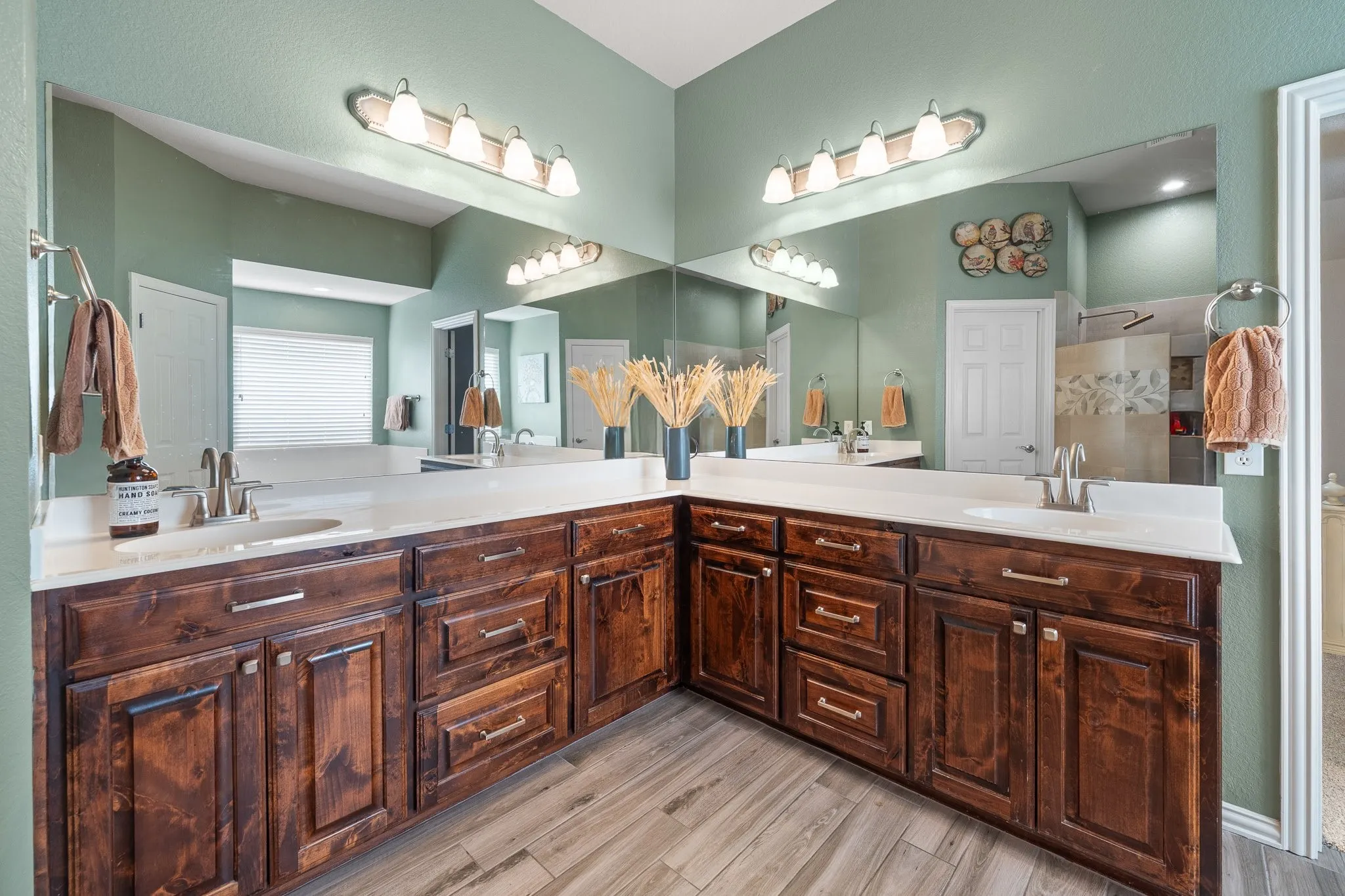 Look at all this counter space in the primary bathroom! Check out all the cabinets, too!