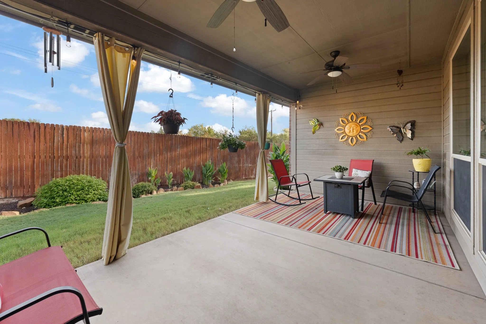You're going to LOVE this covered back patio! And the back yard landscaping is SO pretty!