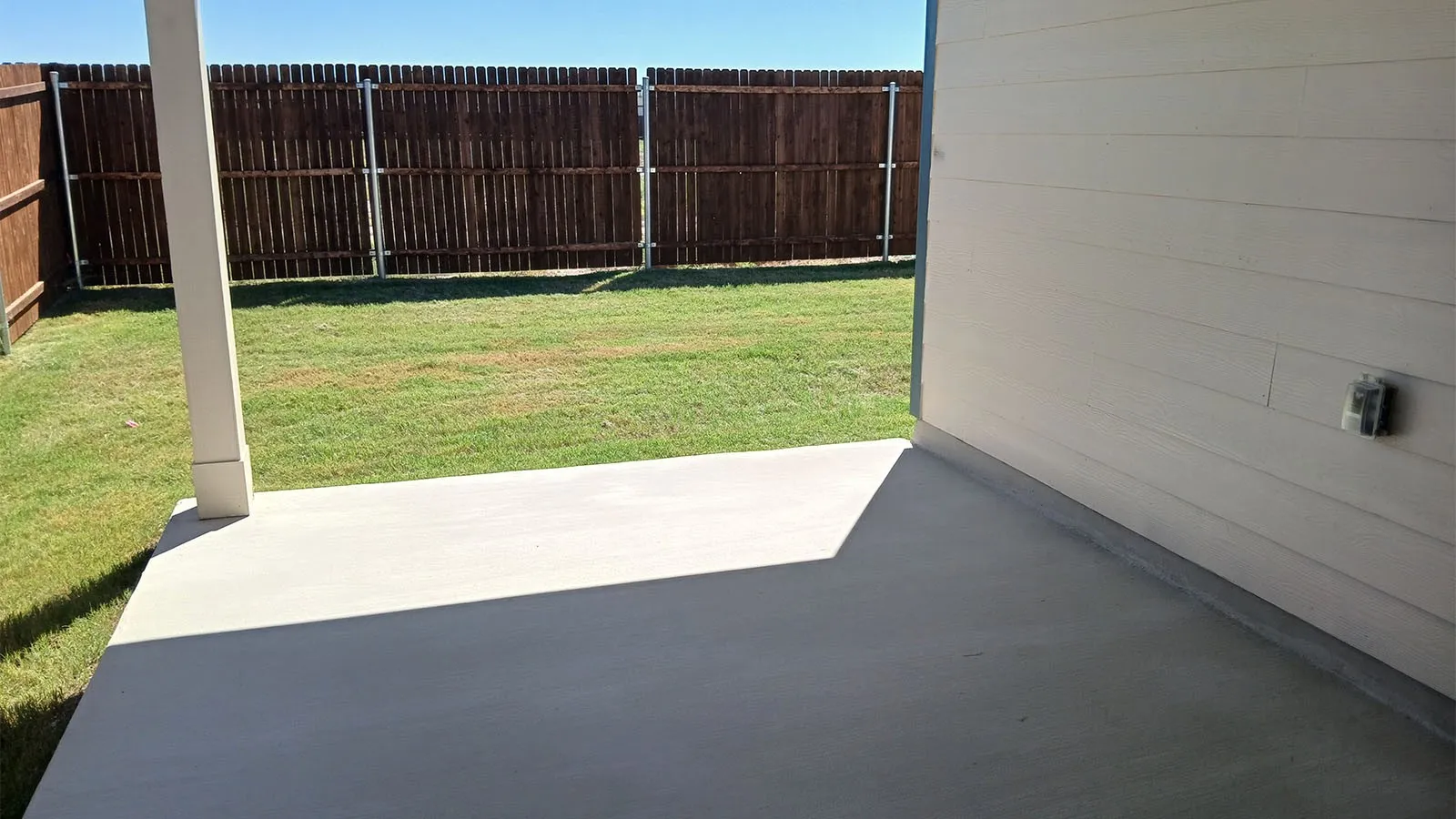 Covered concrete patio with siding exterior