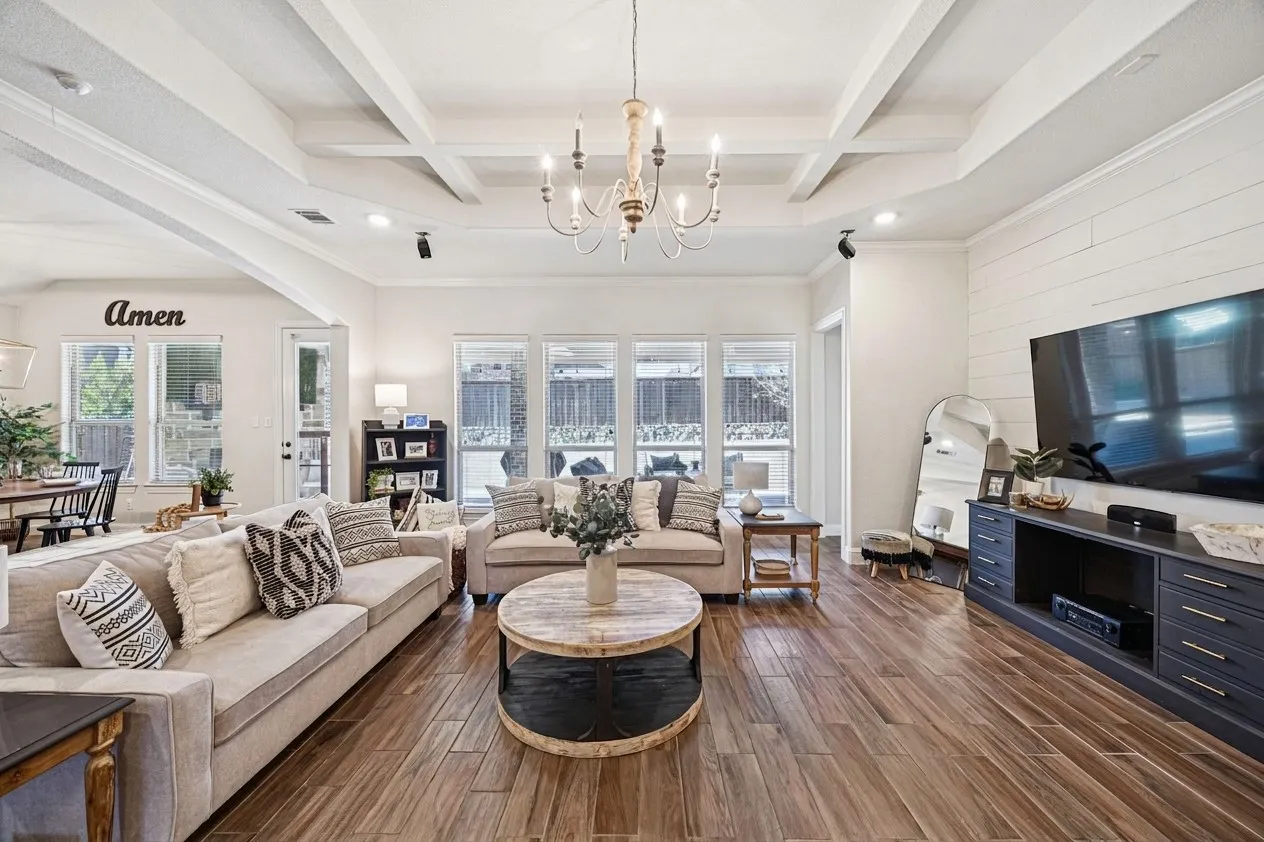 Wood-finish flooring, coffered ceiling, exposed beams, recessed lighting, and a white shiplap-style accent wall