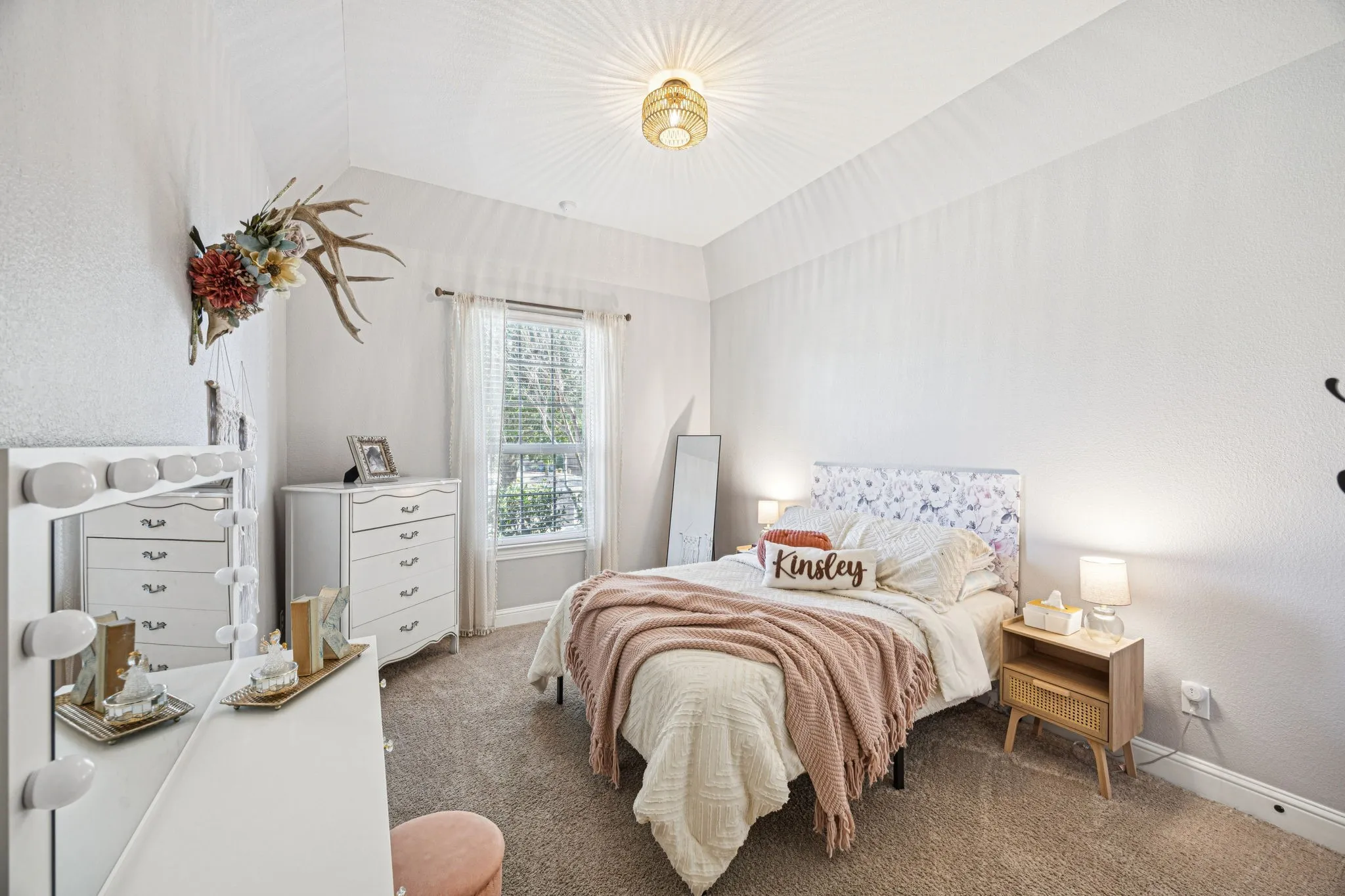 Vaulted ceiling, recessed window, carpet flooring, and a flush-mount ceiling light fixture