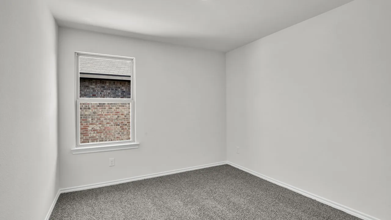 Neutral wall paint, gray carpet flooring, white trim, and a single window