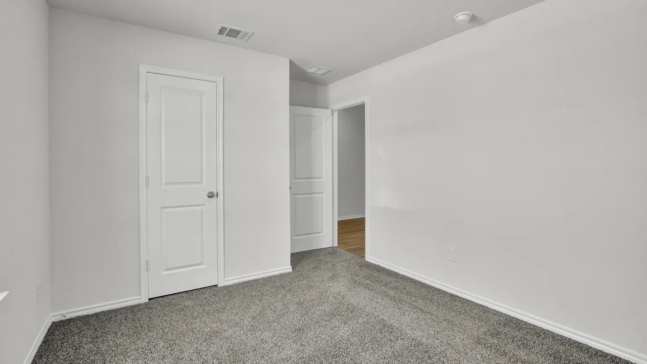 Plush gray carpeting, white walls, and white trim