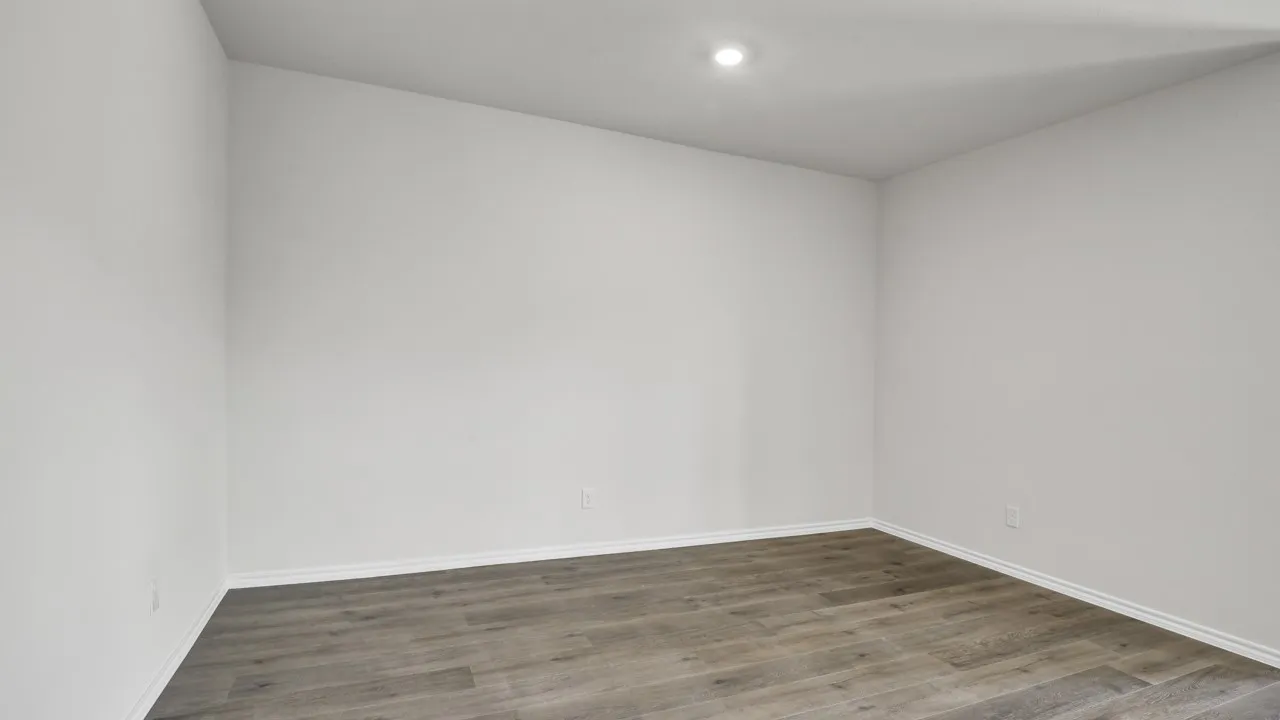 White painted walls with wood-finish flooring and recessed ceiling lighting