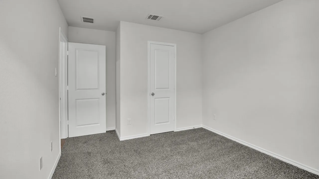 Neutral-toned carpeting paired with white walls, featuring two panel doors