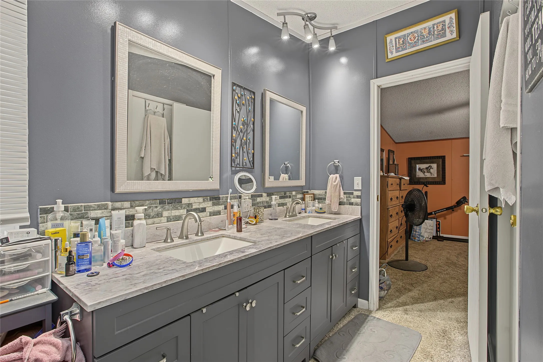 Dual vanity with undermount sinks, gray cabinetry, and light-toned countertop