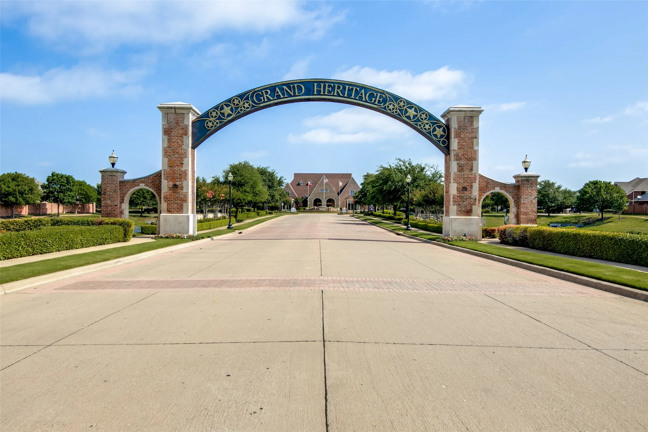 Brick entry columns with integrated lighting and a decorative archway