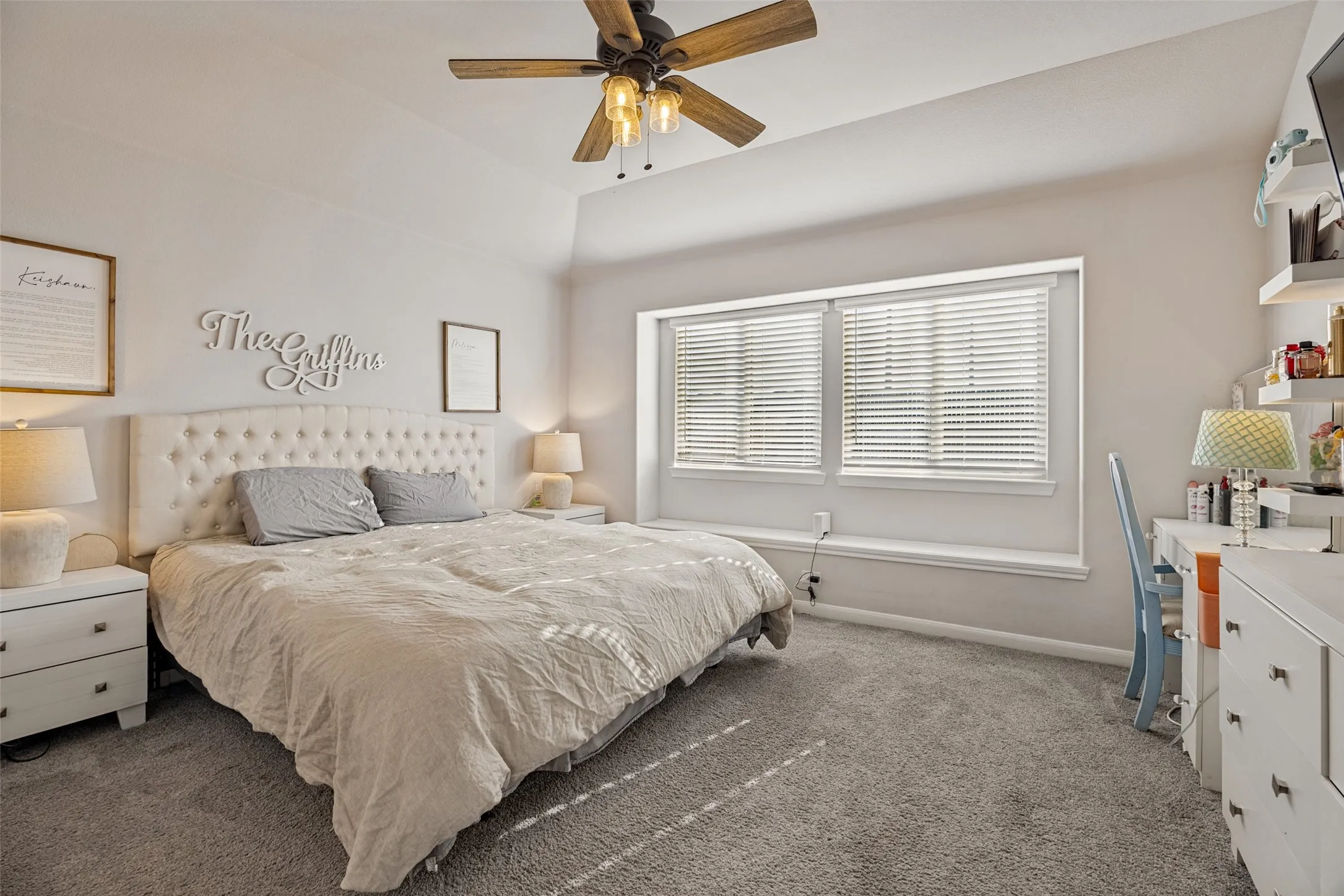 Angled ceiling with a wood-finish ceiling fan and attached lighting