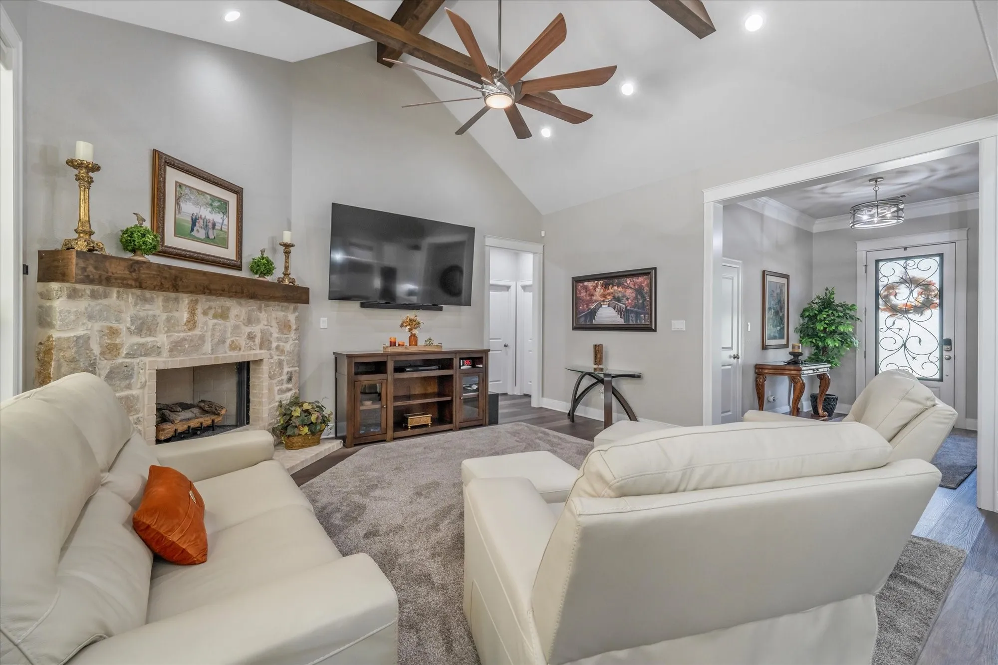 Vaulted ceiling with exposed wood beams and recessed lighting