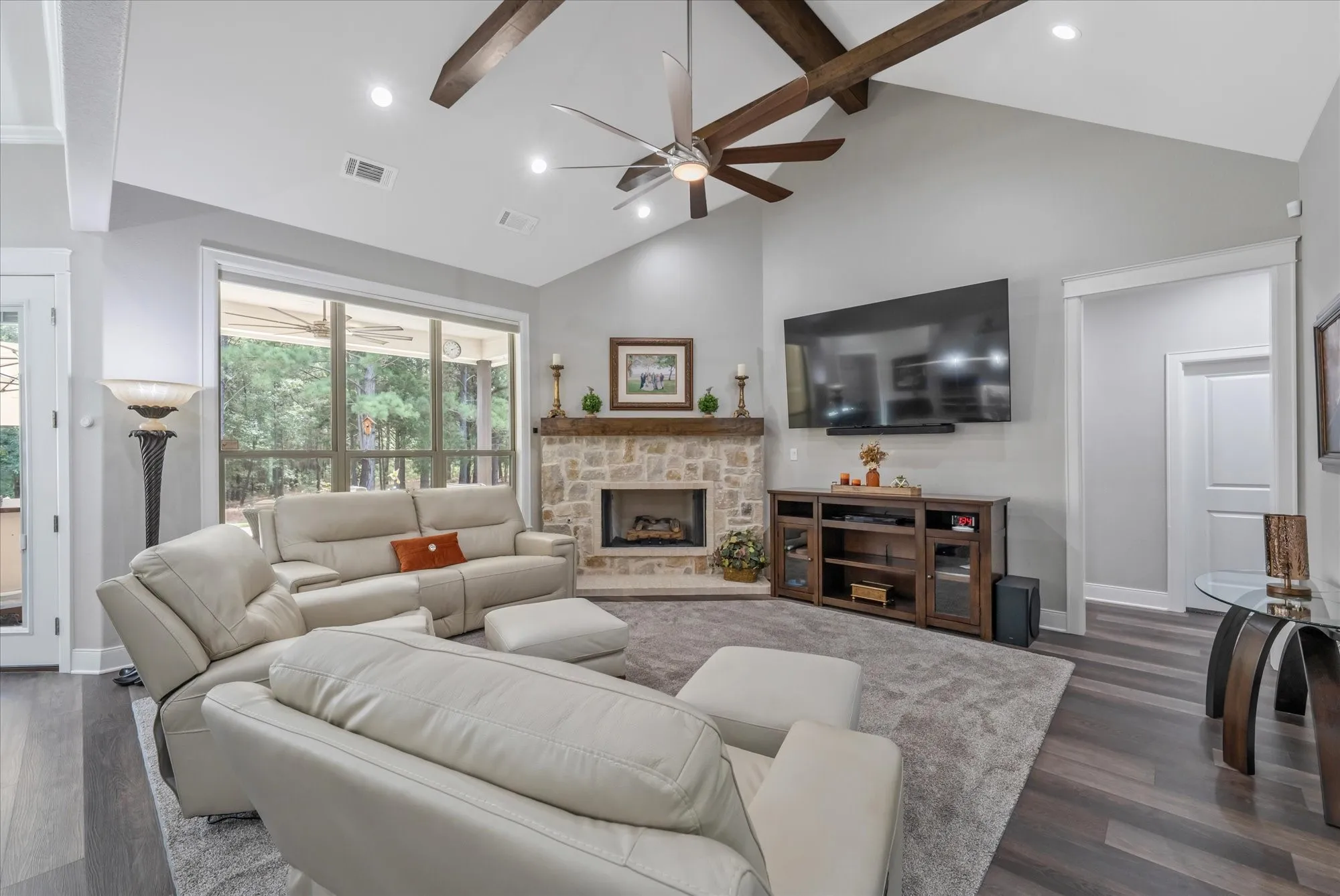 Vaulted ceiling with exposed wood beams and recessed lighting