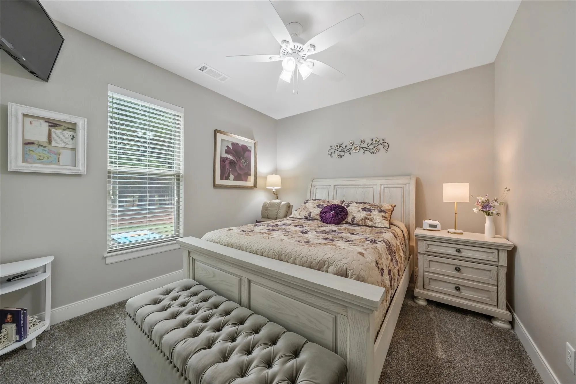 Recessed window with blinds, overhead ceiling fan, and carpeted flooring